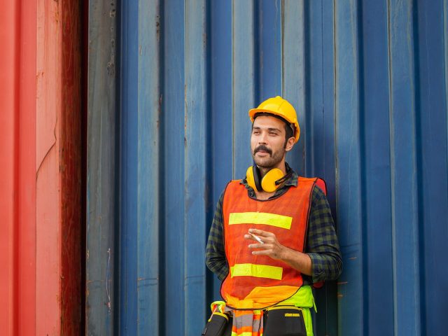 Factory worker with a cigarette smoke break