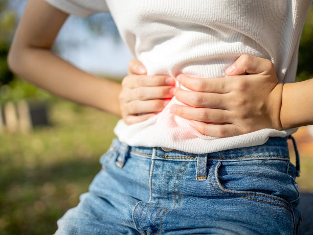 Asian Child Girl With Stomach Ache,woman Having Aching Belly Wit