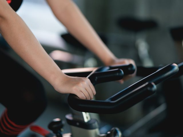 Crop Picture Of Close Up Hand Sportswoman Exercising On A Bicycl