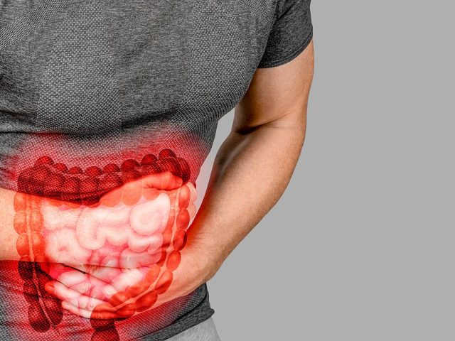 Intestinal Inflammation. Irritable Bowel Syndrome. Man Touching